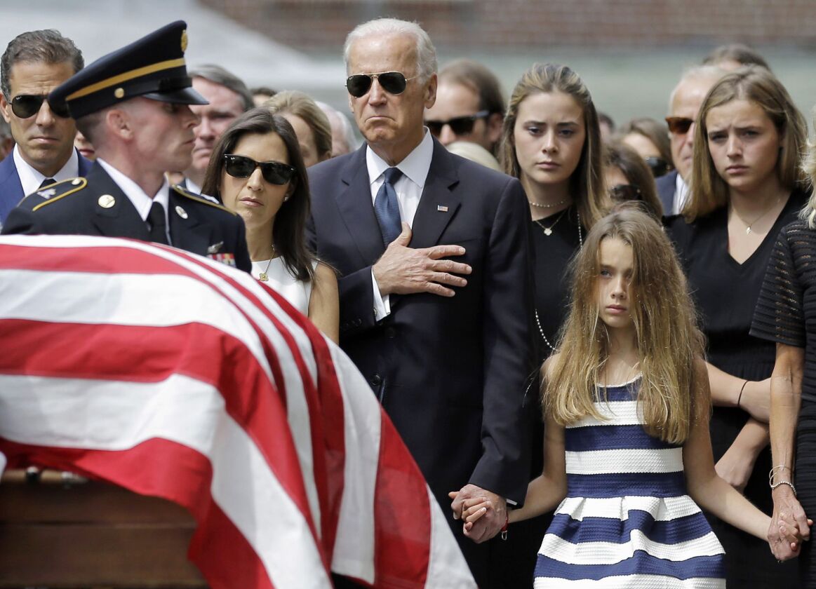<small><strong>Vice President Joe Biden, accompanied by his family, holds his hand over his heart as he watches an honor guard carry a casket containing the remains of his son, former Delaware Attorney General Beau Biden, into St. Anthony of Padua Roman C